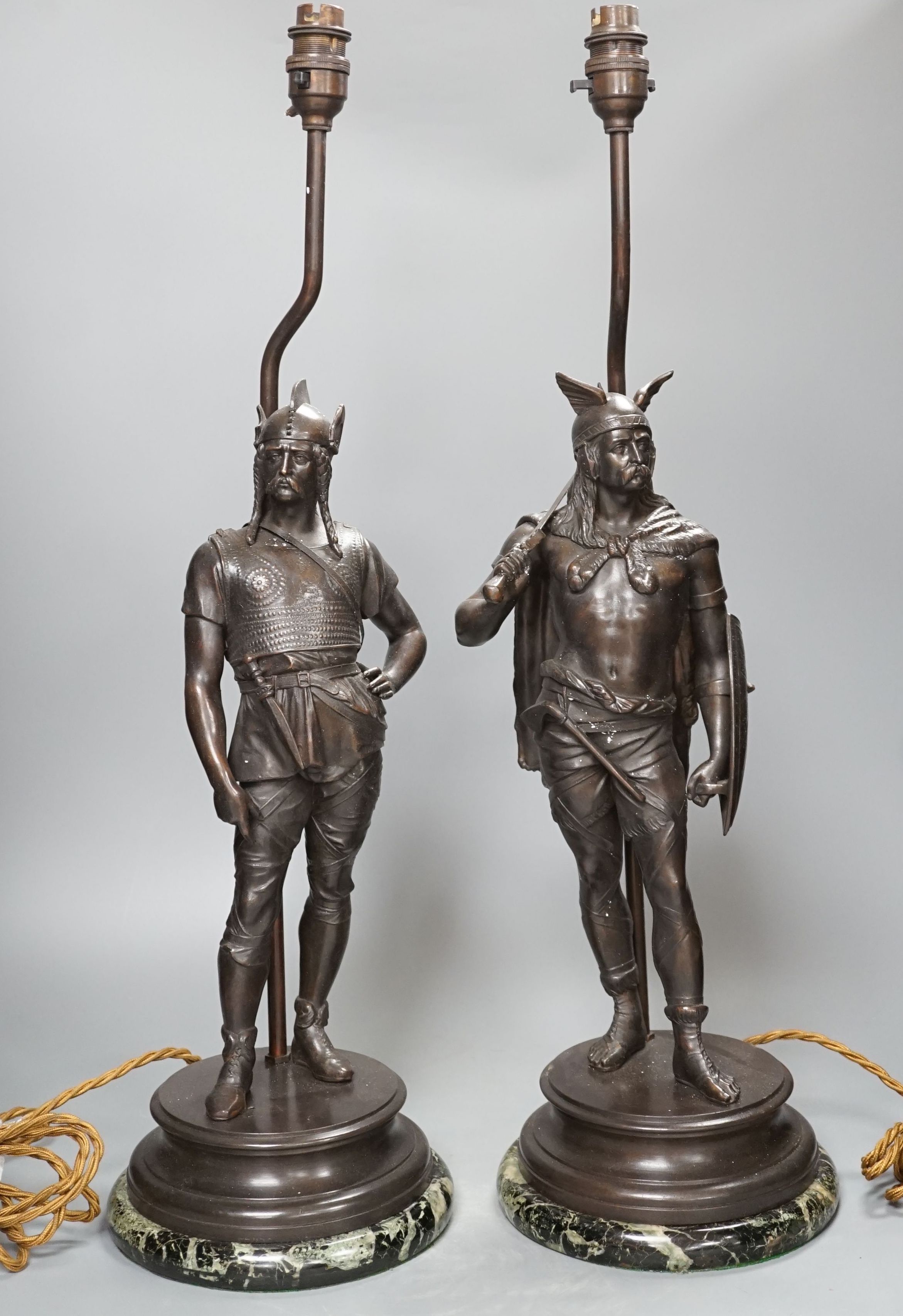 A pair of spelter warrior lamps on marbled plinth base - 62cm high